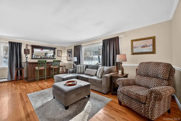 a living room with furniture kitchen view and large window