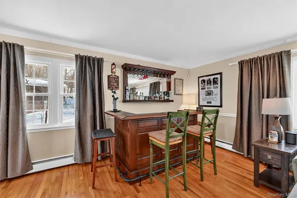 a dining room with furniture and wooden floor