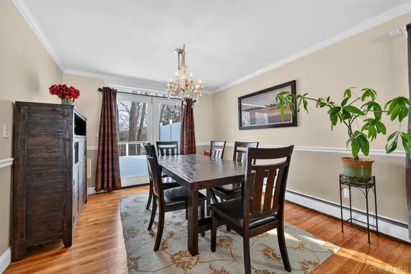 a view of a dining room with furniture wooden floor and chandelier