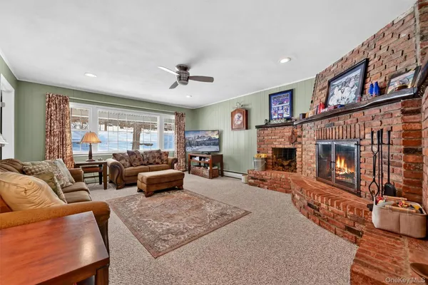 a living room with furniture fireplace and flat screen tv
