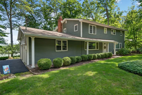 a view of a house with a backyard