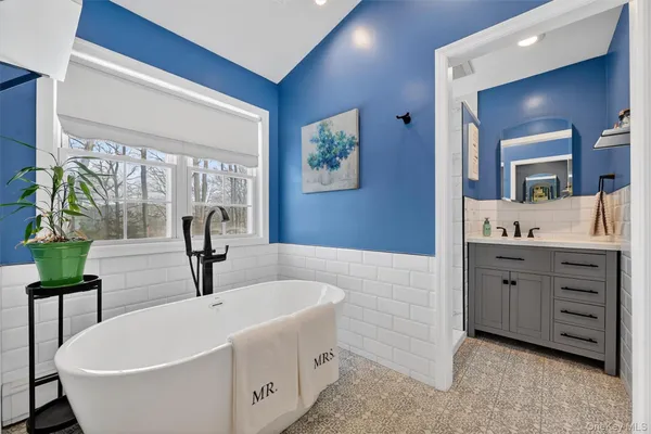 a bathroom with a double vanity sink and a bathtub