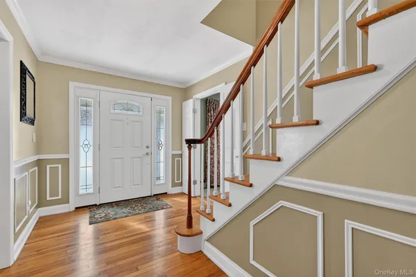 a view of an entryway with wooden floor and door