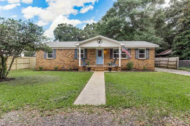 a front view of house with yard and green space