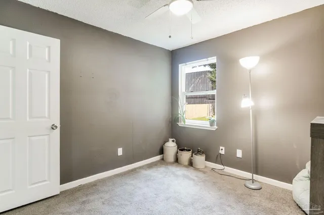 an empty room with windows and closet