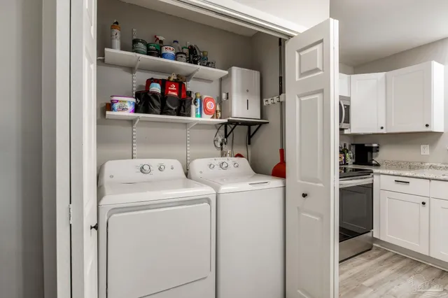 a view of storage and utility room with washer and dryer