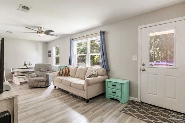 a living room with furniture and a flat screen tv