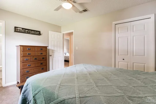 a bedroom with a bed and a closet