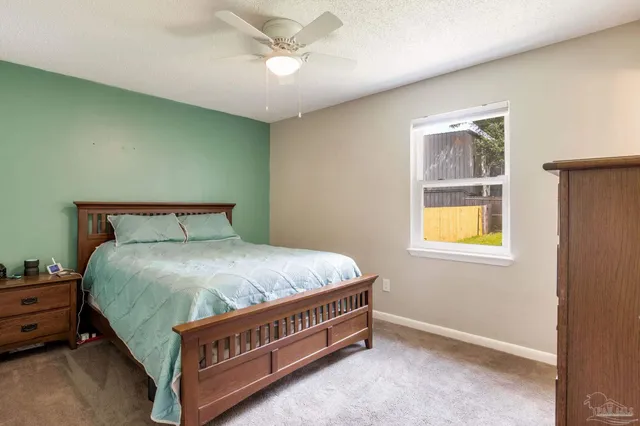 a bed sitting in a room next to a window