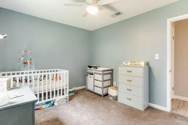 a bedroom with furniture and a baby crib