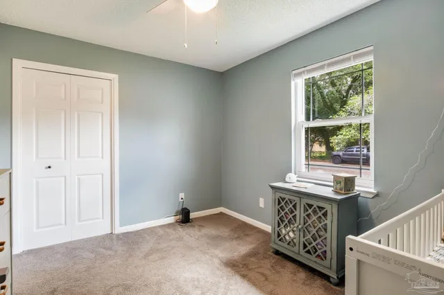 a view of room with window and wooden floor