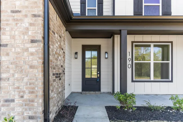 a front view of a house with a plants