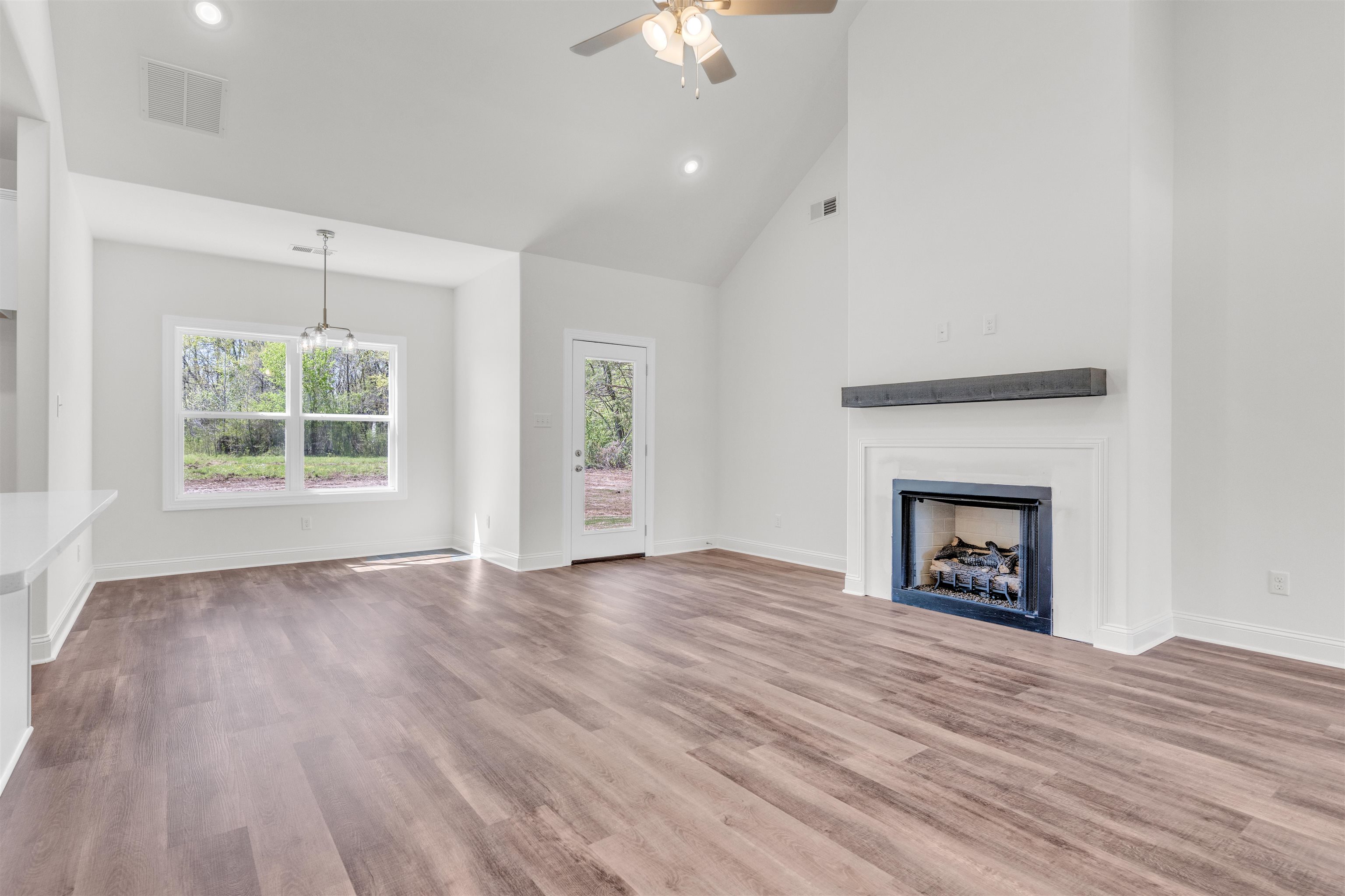 395 Centerline Roper Loop Byhalia, MS 38611 - Photo 7 of 23 a view of an empty room with wooden floor fireplace and a window