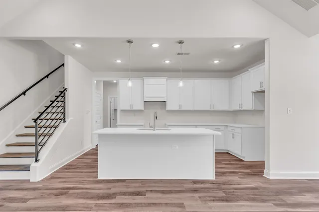 a view of kitchen with wooden floor and electronic appliances
