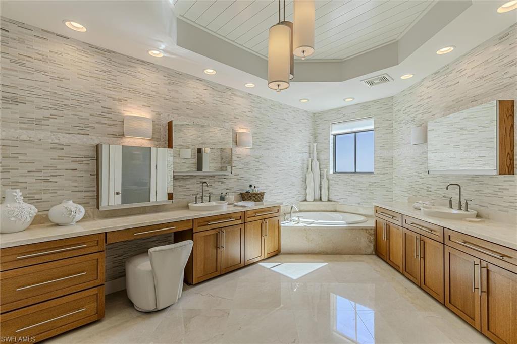 295 Grande Way, Unit PH2 Naples, FL 34110 - Photo 30 of 45 a large kitchen with a large counter space a sink stainless steel appliances and cabinets