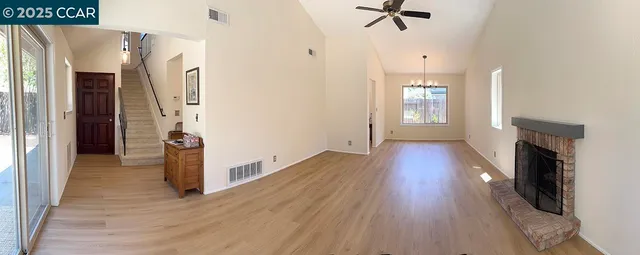 a view of a hallway with wooden floor and a fireplace