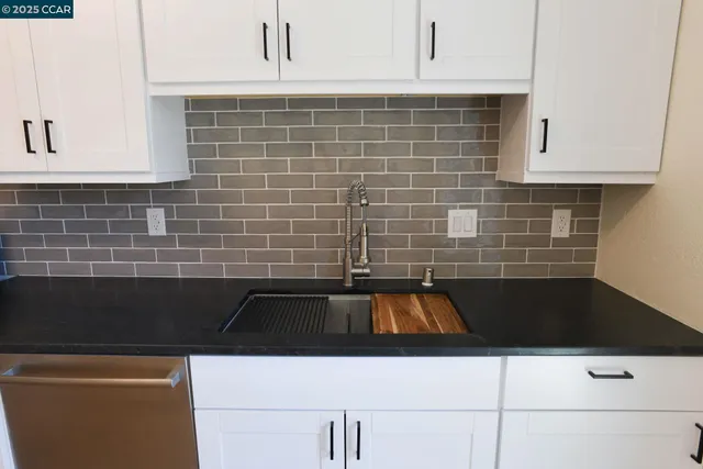 a kitchen with a sink and cabinets