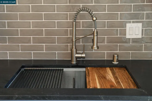 a bathroom with a granite countertop bathtub