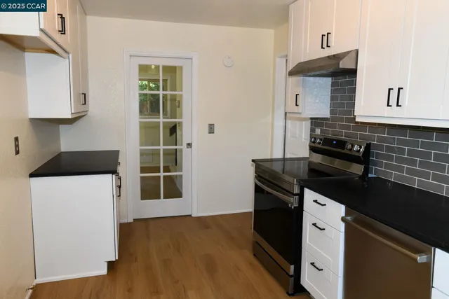 a kitchen with a sink and a stove top oven