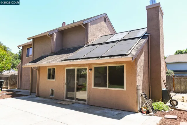 a backyard of a house with potted plants