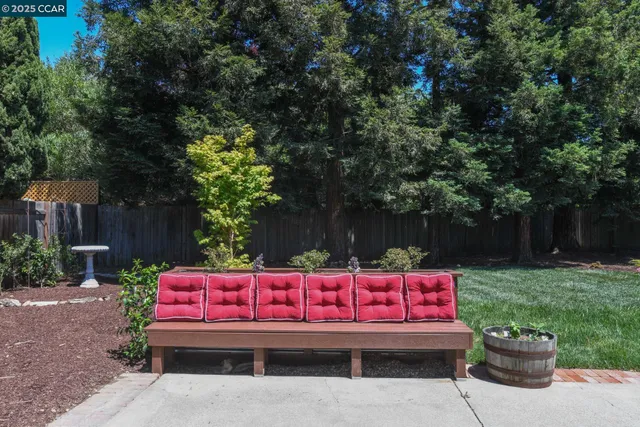 a view of a bench with wooden fence