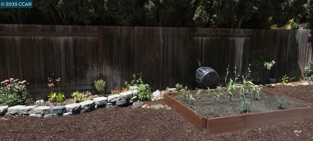 a wooden fence with some plants