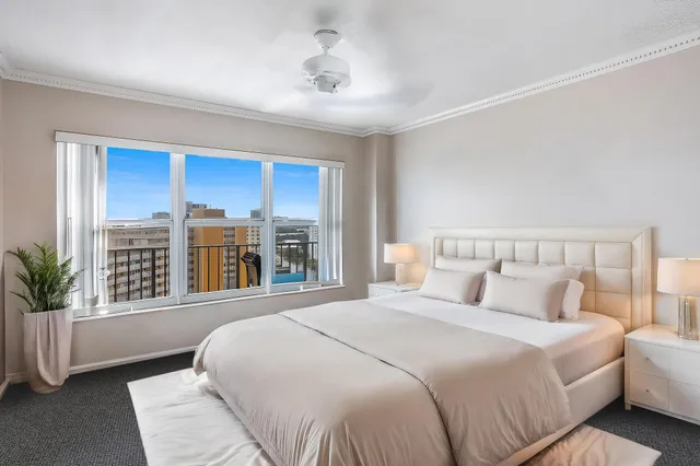 a bedroom with a large bed and a large window