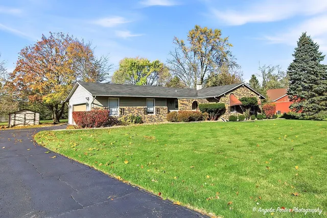 a front view of house with yard and green space