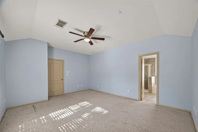 a view of a livingroom with a ceiling fan and window