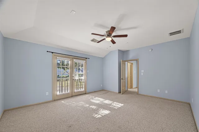 a view of a livingroom with a ceiling fan and window