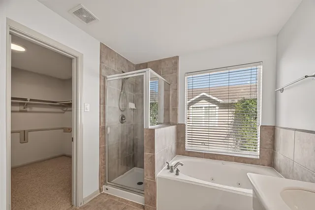 a bathroom with a bathtub and a shower