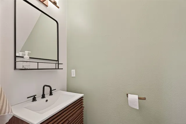 a bathroom with a sink and mirror