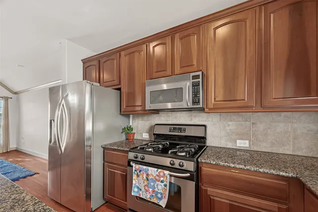 a kitchen with appliances cabinets and a counter top space