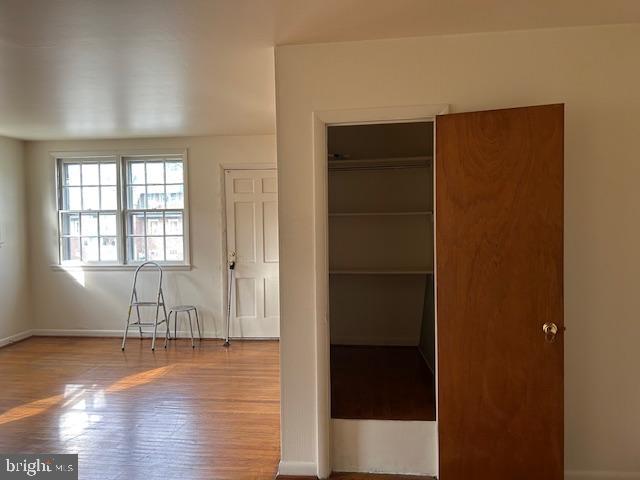 386 Beverly Boulevard, Unit B Upper Darby, PA 19082 - Photo 2 of 7 an empty room with wooden floor and windows