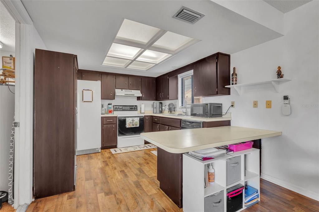 202 Bryan Street Eustis, FL 32726 - Photo 11 of 53 a kitchen that has a lot of cabinets and refrigerator