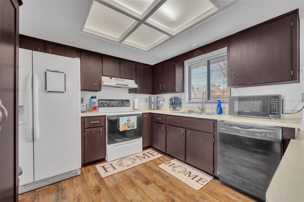 202 Bryan Street Eustis, FL 32726 - Photo 12 of 53 a kitchen with stainless steel appliances granite countertop a stove sink and cabinets