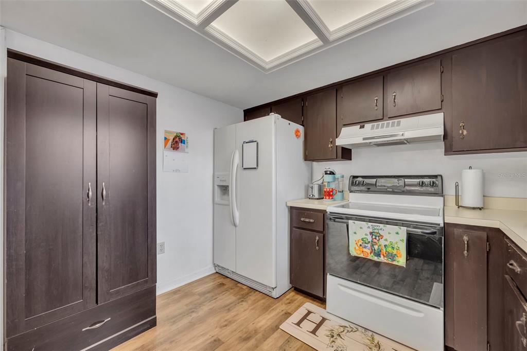 202 Bryan Street Eustis, FL 32726 - Photo 13 of 53 a kitchen with a refrigerator and a stove top oven