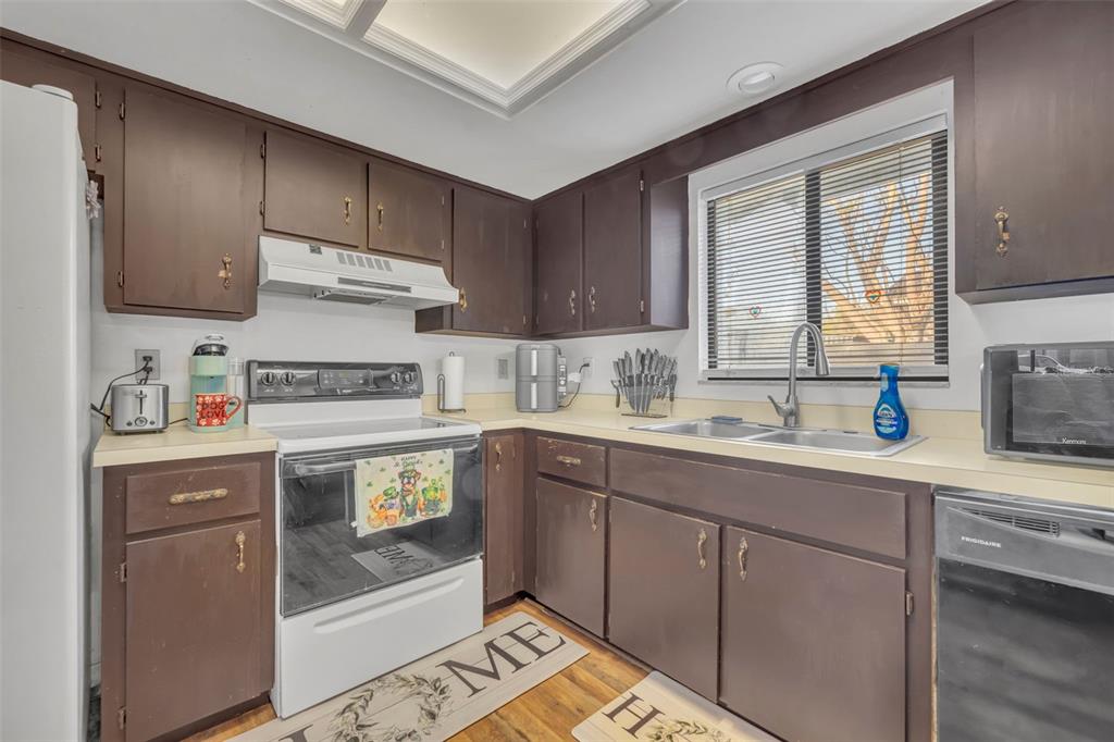 202 Bryan Street Eustis, FL 32726 - Photo 15 of 53 a kitchen with stainless steel appliances a sink stove and cabinets