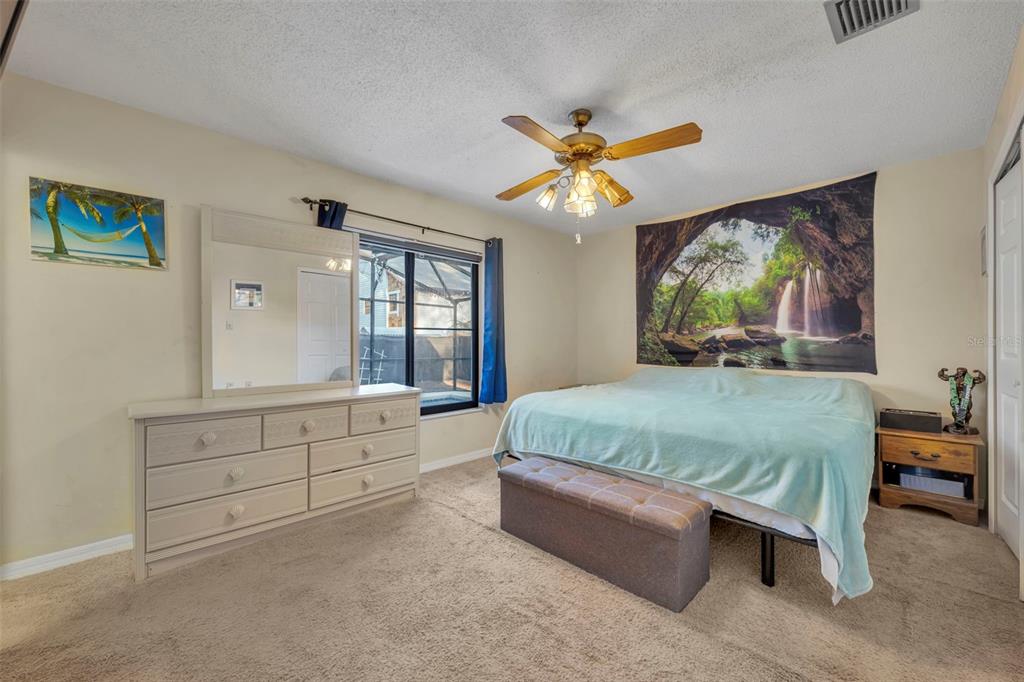 202 Bryan Street Eustis, FL 32726 - Photo 16 of 53 a bedroom with a bed and a large window