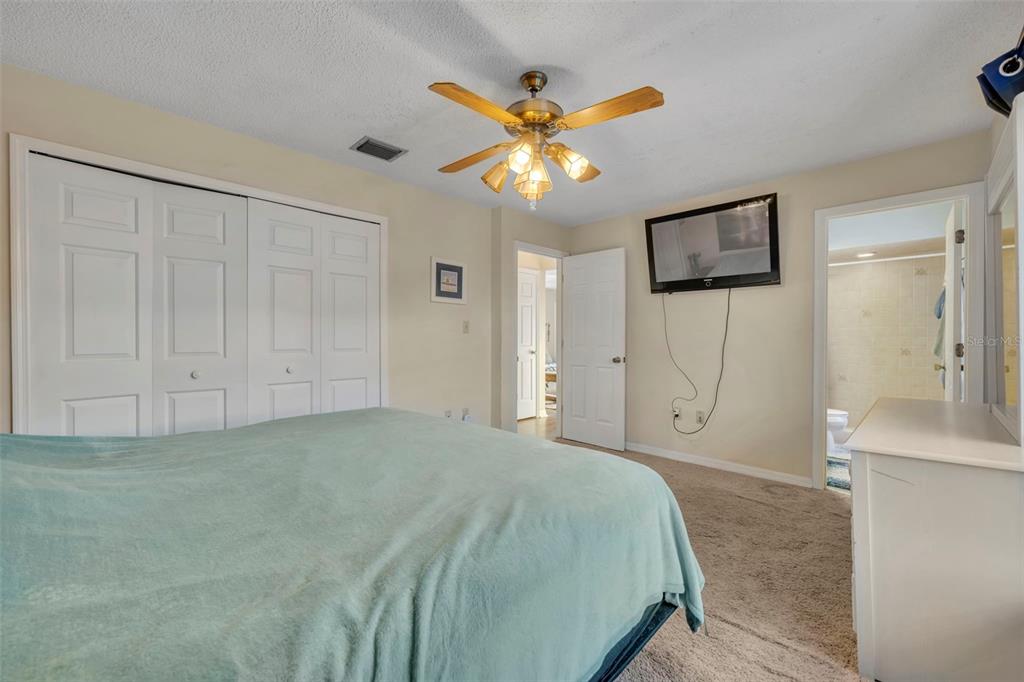 202 Bryan Street Eustis, FL 32726 - Photo 17 of 53 a spacious bedroom with a bed and a chandelier