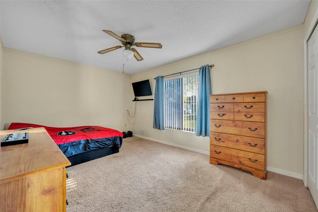 202 Bryan Street Eustis, FL 32726 - Photo 19 of 53 a bedroom with a bed and a cabinets