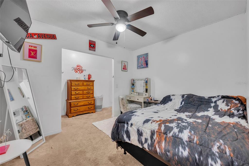 202 Bryan Street Eustis, FL 32726 - Photo 22 of 53 a bedroom with a bed and a chandelier