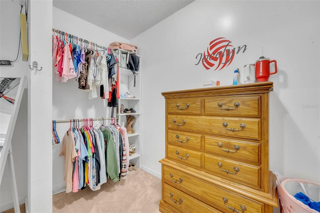 202 Bryan Street Eustis, FL 32726 - Photo 23 of 53 a view of walk in closet with clothes