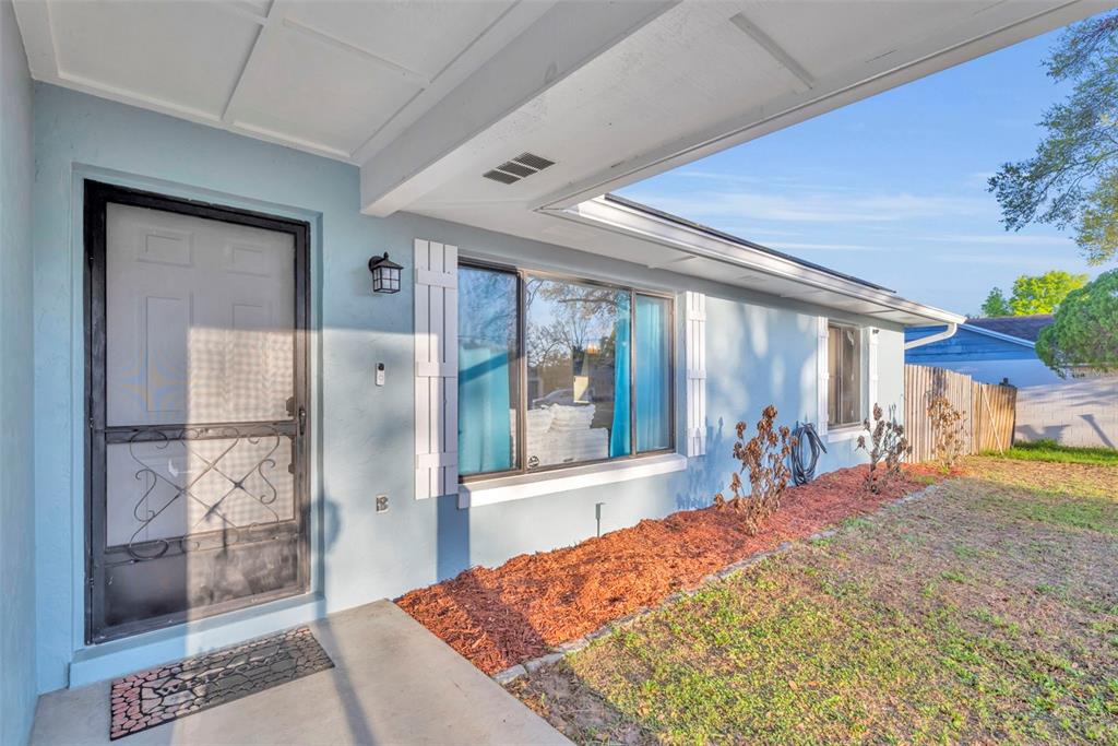 202 Bryan Street Eustis, FL 32726 - Photo 3 of 53 a bedroom with a bed and a large window with the outer view
