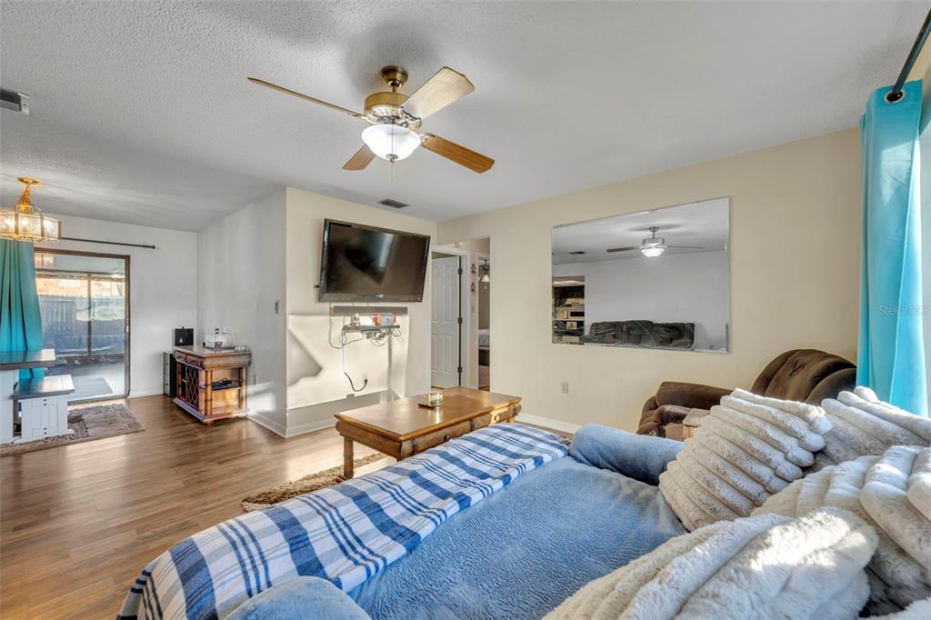 202 Bryan Street Eustis, FL 32726 - Photo 5 of 53 a living room with furniture and a flat screen tv