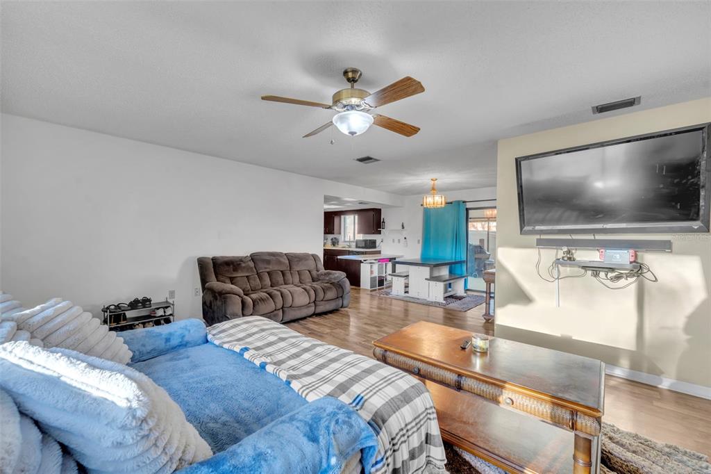 202 Bryan Street Eustis, FL 32726 - Photo 8 of 53 a living room with furniture and a flat screen tv