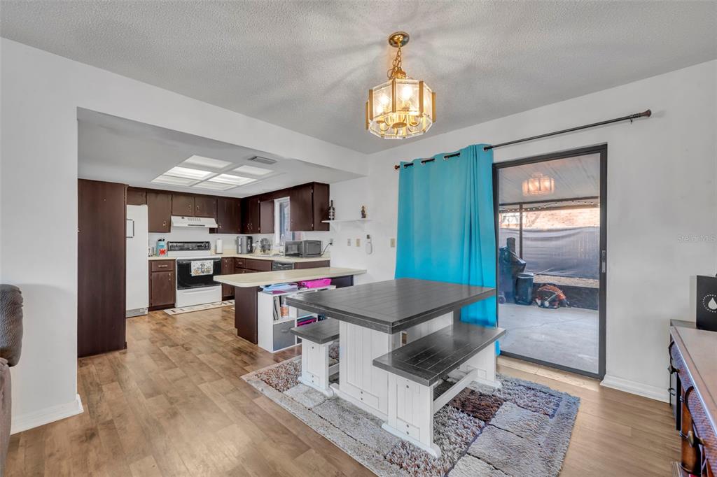 202 Bryan Street Eustis, FL 32726 - Photo 9 of 53 a open kitchen with stainless steel appliances granite countertop a stove and a refrigerator