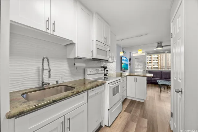 a kitchen with a sink stove and cabinets