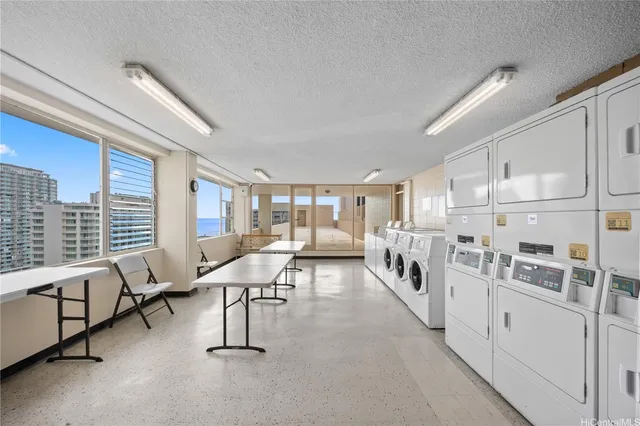a living room with furniture a fireplace and large windows