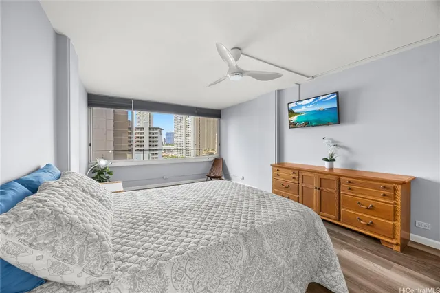 a bedroom with a large bed and a window